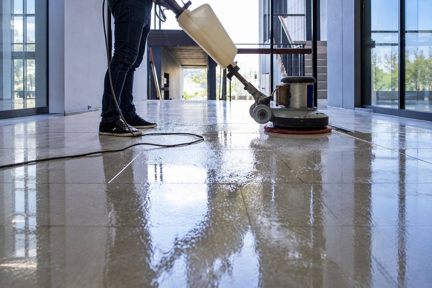 Commercial tile floor being machine scrubbed to a shine